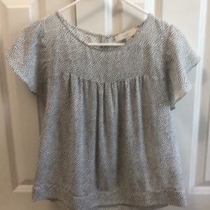 Polka dot top sits at the hips for 5 ft person